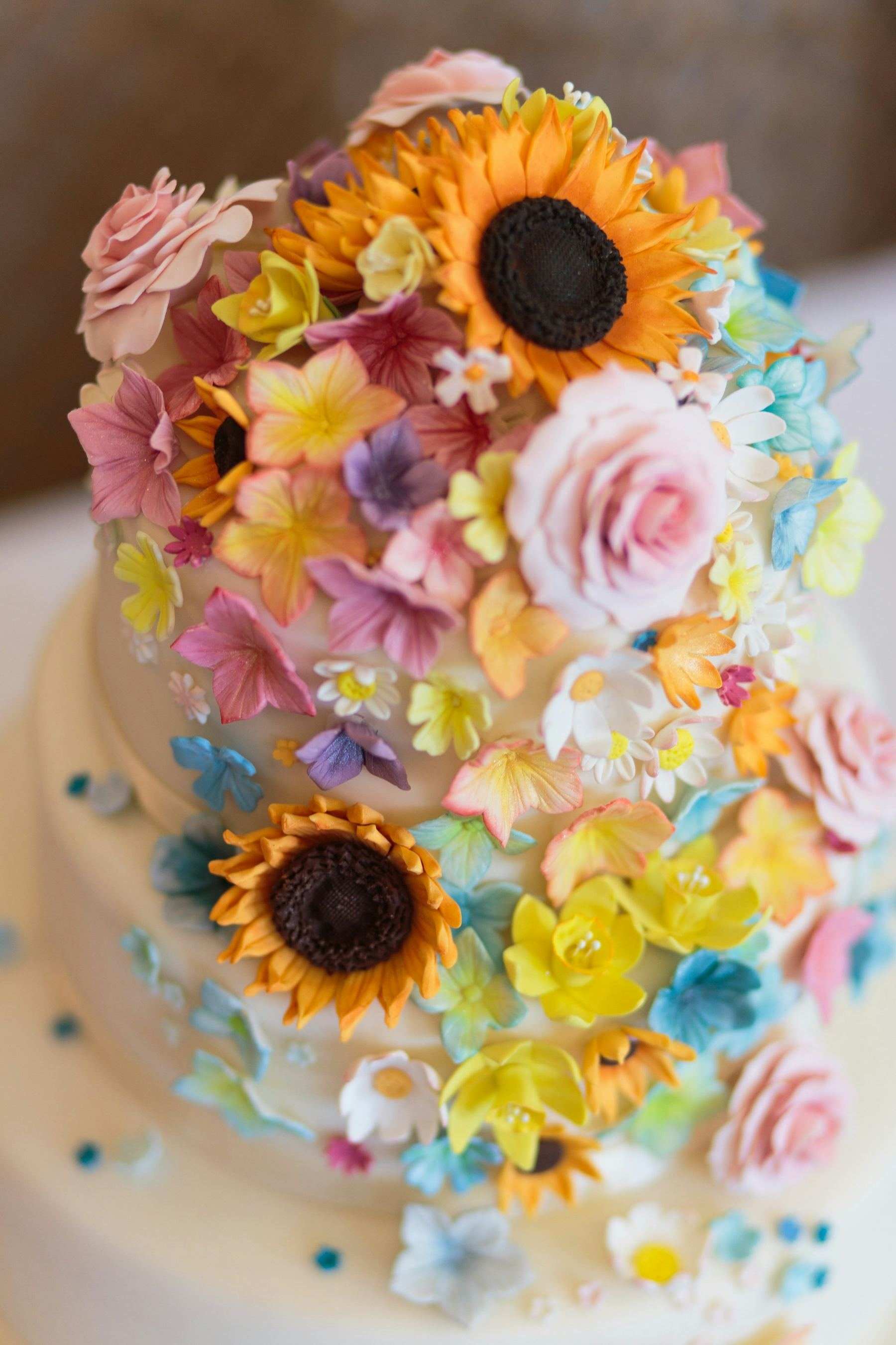 A cake decorated with colourful edible flowers